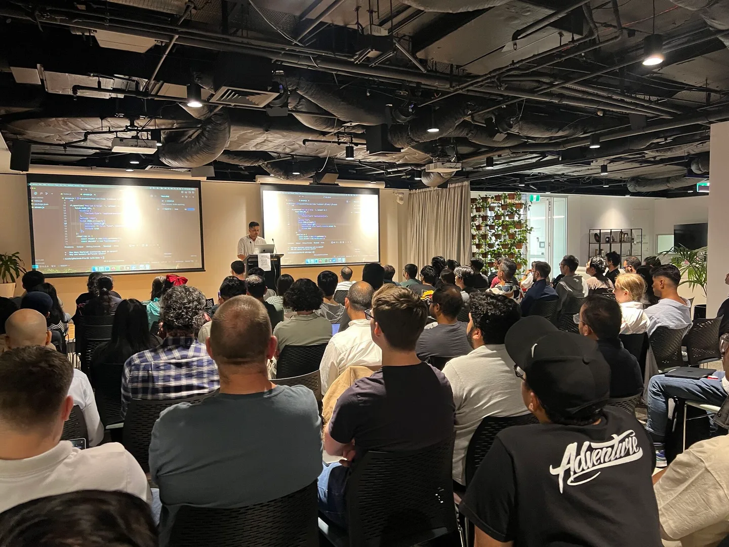 A full room of developers watching a live code presentation at GDG Melbourne’s Build with AI event