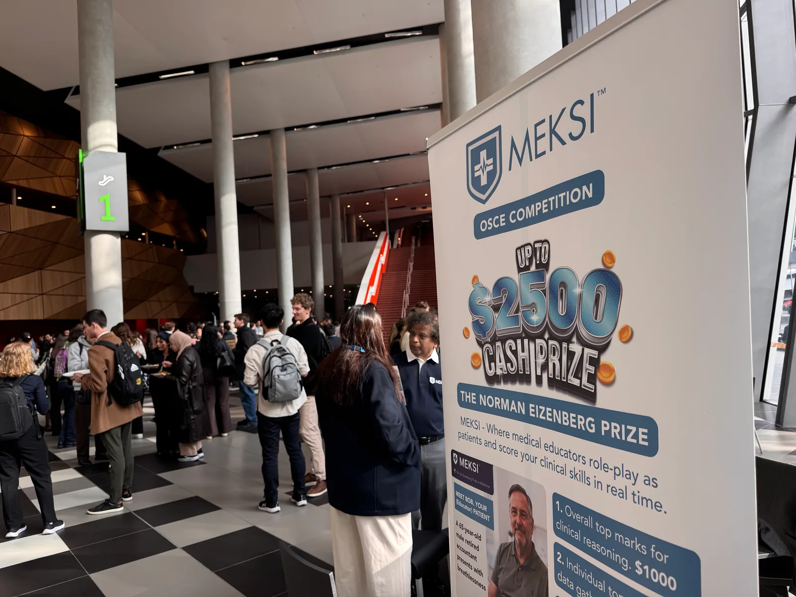 The MEKSI OSCE competition stand and attendees at the University of Melbourne MD Students Conference